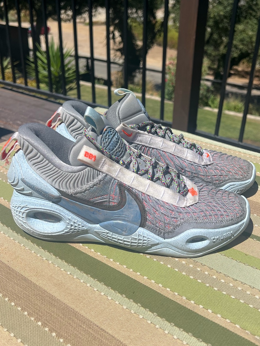 Nike Cosmic Unity Grey Sneakers with Light Blue Soles and Orange Accents
